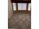 Open-plan living room with neutral walls, multiple windows, and tile flooring at 3510 E Hampton Ave # 133, Mesa, AZ 85204