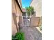 Enclosed side yard featuring desert landscaping, a block wall, and a white metal gate at 3510 E Hampton Ave # 133, Mesa, AZ 85204