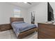 Bedroom featuring a wooden bed frame, matching nightstand and dresser, and closet with clothing racks at 37103 N El Morro Trl, San Tan Valley, AZ 85140
