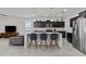 Modern kitchen boasting granite countertops, stainless steel appliances, and a breakfast bar, enhancing convenience at 37103 N El Morro Trl, San Tan Valley, AZ 85140
