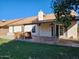 Exterior backyard featuring a covered patio, lush lawn, a built-in hot tub, and privacy fencing at 3853 W Calle Lejos --, Glendale, AZ 85310