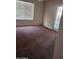 Bedroom with neutral walls, plush carpeting, a large window, and a glass-paneled door at 3853 W Calle Lejos --, Glendale, AZ 85310
