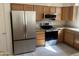 Modern kitchen with stainless steel appliances, granite countertops, and light wood cabinets at 3853 W Calle Lejos --, Glendale, AZ 85310