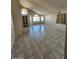 Spacious living room featuring tile flooring, high ceilings, large windows, and ample natural light at 3853 W Calle Lejos --, Glendale, AZ 85310