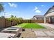 Beautiful backyard with putting green, fire pit, lush lawn, and inviting outdoor living spaces at 3915 N Shannon Cir, Mesa, AZ 85215