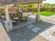 Well-equipped backyard featuring an outdoor kitchen, covered patio, putting green, and mature landscaping at 3915 N Shannon Cir, Mesa, AZ 85215