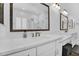 Bathroom with double sink vanity, granite countertops and wood framed mirrors at 3915 N Shannon Cir, Mesa, AZ 85215