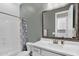 Cozy bathroom with white vanity, framed mirror, tub, and shower featuring stylish accents and hardware at 3915 N Shannon Cir, Mesa, AZ 85215