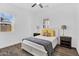 Bright bedroom with a ceiling fan, shuttered windows and wood-look tile floors at 3915 N Shannon Cir, Mesa, AZ 85215