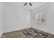 Bright bedroom with shuttered window, dark ceiling fan, wood-look flooring and area rug at 3915 N Shannon Cir, Mesa, AZ 85215