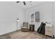 Bright bedroom featuring wood-look tile, stylish furniture, and a ceiling fan for added comfort at 3915 N Shannon Cir, Mesa, AZ 85215