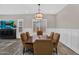 Comfortable dining room with decorative lighting, wainscoting, and a view of the living room at 3915 N Shannon Cir, Mesa, AZ 85215