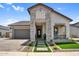 Charming home featuring a stone facade, meticulously landscaped front yard, and an attached garage at 3915 N Shannon Cir, Mesa, AZ 85215