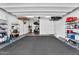 Spacious garage with epoxy flooring, shelving for storage, and ample room for vehicles and equipment at 3915 N Shannon Cir, Mesa, AZ 85215