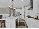 Open concept kitchen features white cabinets, stainless steel appliances, and a large island with seating at 3915 N Shannon Cir, Mesa, AZ 85215
