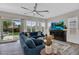 Spacious living room featuring a large sectional, wood floors, ample natural light, and backyard access at 3915 N Shannon Cir, Mesa, AZ 85215