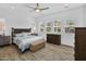 Spacious main bedroom featuring natural light, a ceiling fan, and wood-look tile floors at 3915 N Shannon Cir, Mesa, AZ 85215