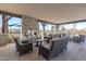 An inviting outdoor patio seating area with a cozy fireplace for relaxing and entertaining friends at 3915 N Shannon Cir, Mesa, AZ 85215