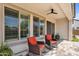 Cozy outdoor patio with comfortable chairs, ceiling fan, and beautiful tiled flooring at 3915 N Shannon Cir, Mesa, AZ 85215