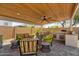 Charming patio featuring comfortable seating, ceiling fan, and a convenient outdoor grill area at 3915 N Shannon Cir, Mesa, AZ 85215