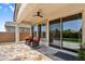 Covered patio featuring tiled floors, ceiling fan, and comfortable chairs, ideal for outdoor relaxation at 3915 N Shannon Cir, Mesa, AZ 85215