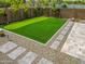 A well-maintained backyard putting green with stone pavers, gravel, and desert landscaping at 3915 N Shannon Cir, Mesa, AZ 85215
