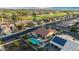 Overhead view of a home with solar panels, a pool, a putting green, and proximity to a golf course at 4029 N 160Th Dr, Goodyear, AZ 85395