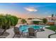 An expansive backyard featuring a sparkling pool, a hot tub, and lush landscaping at 4029 N 160Th Dr, Goodyear, AZ 85395