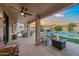 Covered patio provides a relaxing outdoor retreat, overlooking the pool and landscaped backyard at 4029 N 160Th Dr, Goodyear, AZ 85395