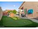 Lush backyard with artificial putting green, outdoor grill and seating near the pool at 4029 N 160Th Dr, Goodyear, AZ 85395
