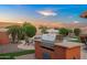 Tranquil backyard featuring a built-in grill, seating area, and sparkling pool at 4029 N 160Th Dr, Goodyear, AZ 85395