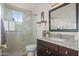 Well-lit bathroom featuring a sleek design with granite countertop, tile flooring, and modern fixtures at 4029 N 160Th Dr, Goodyear, AZ 85395