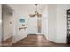 Bright foyer featuring wood floors and a stylish light fixture at 4029 N 160Th Dr, Goodyear, AZ 85395