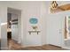 Bright foyer featuring a floating shelf, light paint, and wood flooring at 4029 N 160Th Dr, Goodyear, AZ 85395