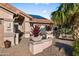 Covered front entrance with potted plants, desert landscaping, and solar panels at 4029 N 160Th Dr, Goodyear, AZ 85395