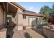 Covered front entrance with potted plants and desert landscaping at 4029 N 160Th Dr, Goodyear, AZ 85395