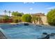 Inviting hot tub featuring a cascading waterfall, lush landscaping, and an open view at 4029 N 160Th Dr, Goodyear, AZ 85395