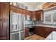 Close up of the kitchen featuring stainless steel appliances and dark wood cabinetry at 4029 N 160Th Dr, Goodyear, AZ 85395