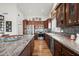 A stylish kitchen featuring granite countertops, stainless steel appliances, and wood cabinets at 4029 N 160Th Dr, Goodyear, AZ 85395