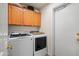 Functional laundry room with modern washer and dryer and ample cabinet space above at 4029 N 160Th Dr, Goodyear, AZ 85395