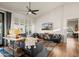 Bright living room featuring hardwood floors, shutters, and a ceiling fan at 4029 N 160Th Dr, Goodyear, AZ 85395