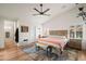 A spacious main bedroom with a ceiling fan, and light-colored walls and wood flooring at 4029 N 160Th Dr, Goodyear, AZ 85395