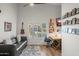 Office space featuring a couch, desk and a wall decorated with photos at 4029 N 160Th Dr, Goodyear, AZ 85395