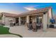 Relaxing backyard patio with outdoor TV, fireplace, dining area and outdoor seating at 4029 N 160Th Dr, Goodyear, AZ 85395