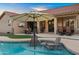 Relaxing backyard patio with an outdoor television, dining area, and cozy fire pit at 4029 N 160Th Dr, Goodyear, AZ 85395