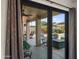 View of the patio, pool, and backyard through sliding glass doors at 4029 N 160Th Dr, Goodyear, AZ 85395