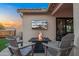 Cozy patio with a fire pit and mounted TV for outdoor enjoyment at 4029 N 160Th Dr, Goodyear, AZ 85395