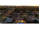 An aerial view shows a home with a backyard pool in a neighborhood under a colorful twilight sky at 421 N Evergreen St, Chandler, AZ 85225