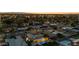 An aerial view shows a home with a backyard pool in a neighborhood under a colorful twilight sky at 421 N Evergreen St, Chandler, AZ 85225