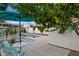 Back yard showing sparkling pool, white fencing, outdoor furniture, patio cover, and mature landscaping at 421 N Evergreen St, Chandler, AZ 85225